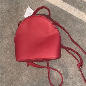 Mini red backpack with adjustable straps